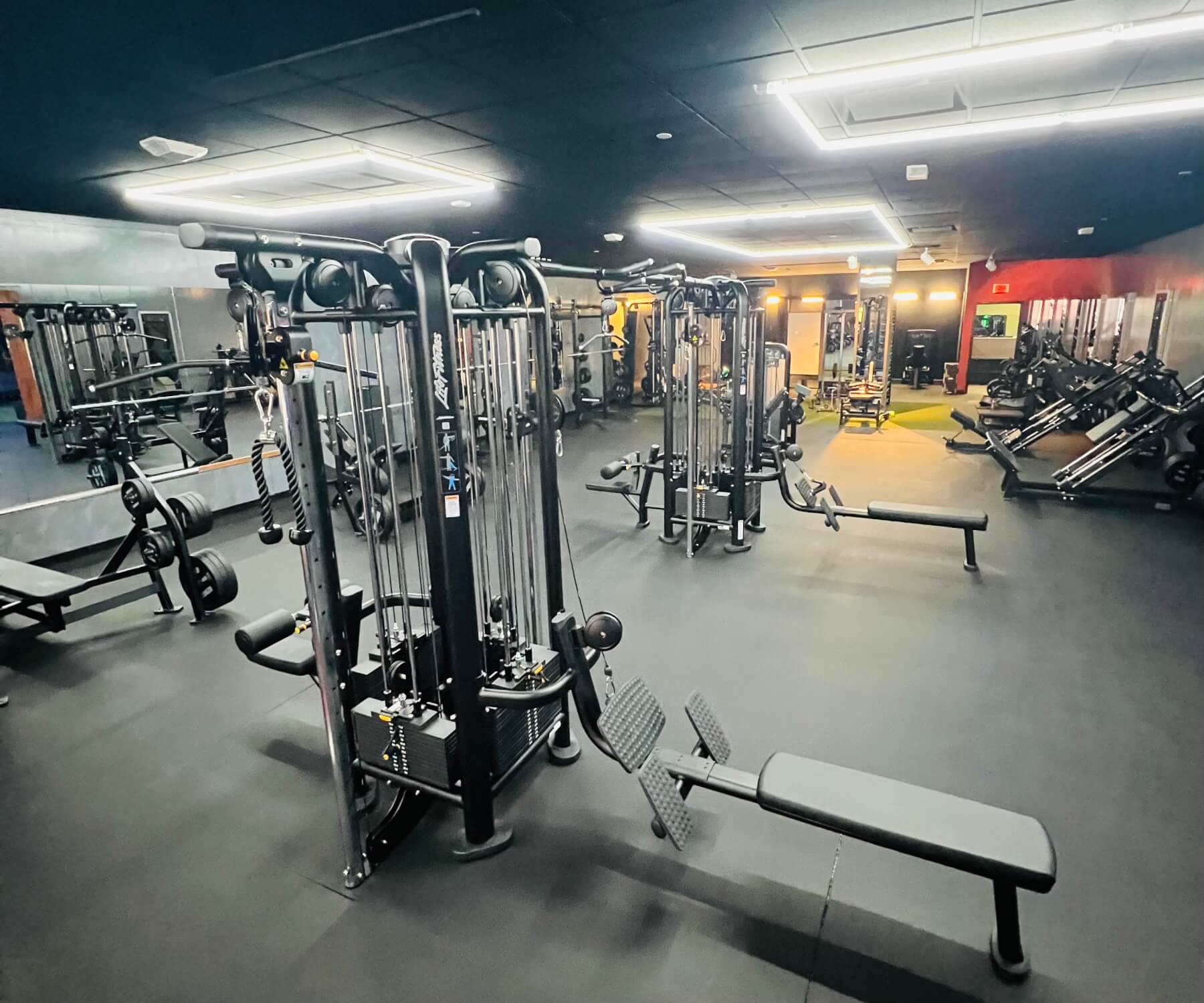 Calle Strength House gym floor with cable machines and strength equipment